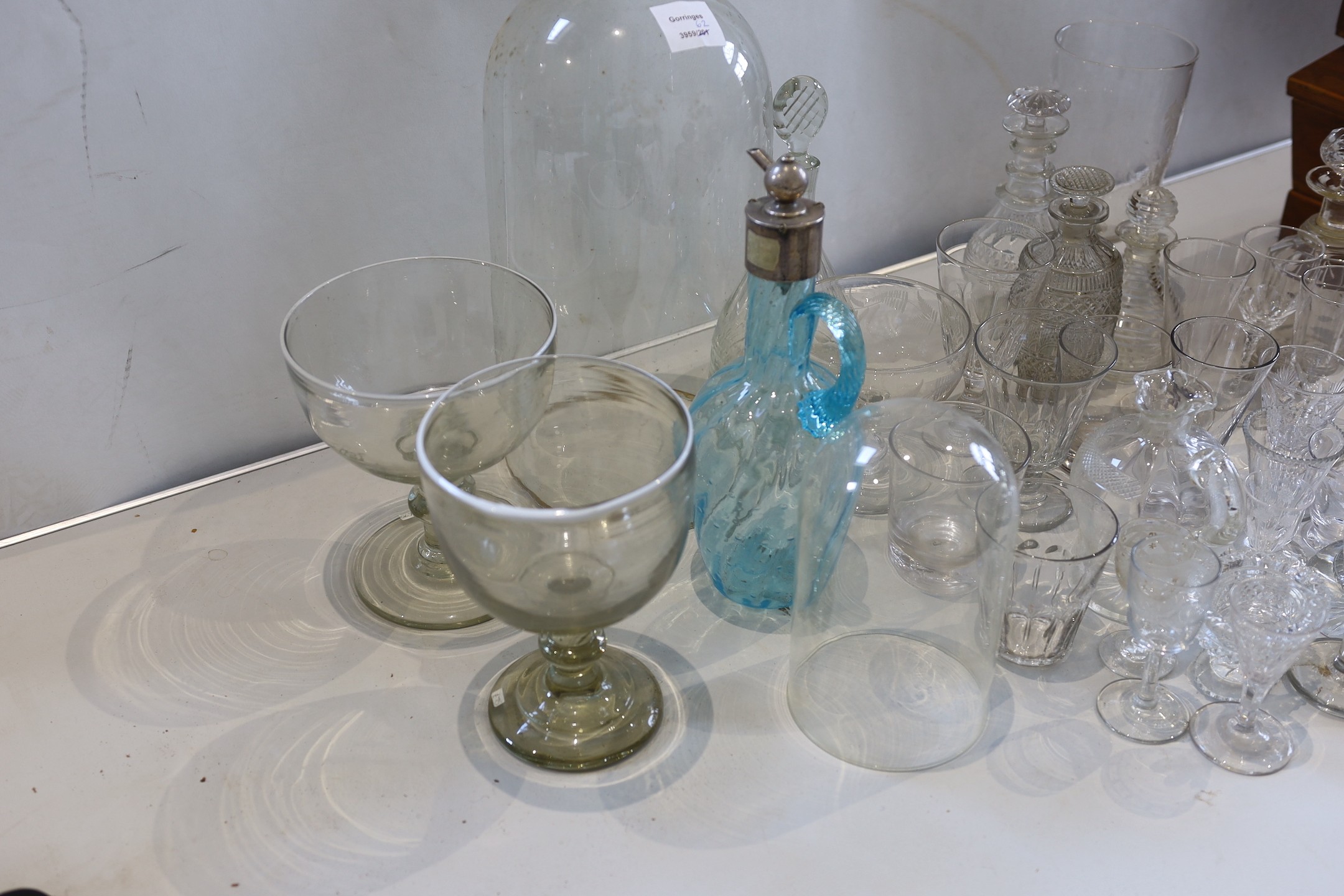A collection of 19th century and later decanters, drinking glasses, oil bottles etc.
